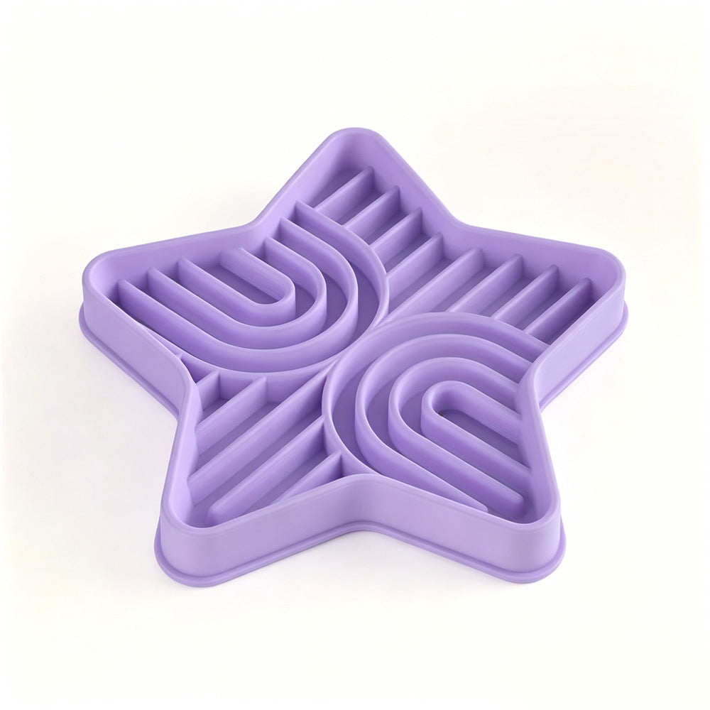 Pet eating from a star-shaped silicone slow feeder mat