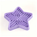 Pet eating from a star-shaped silicone slow feeder mat