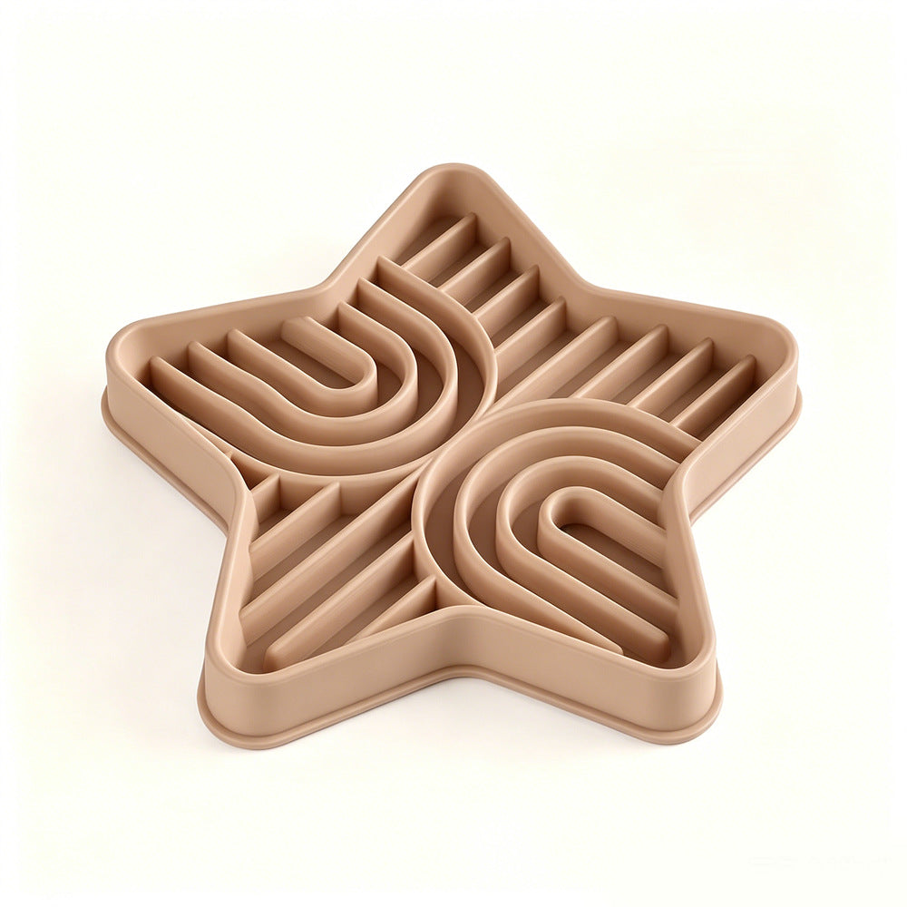 Pet eating from a star-shaped silicone slow feeder mat