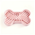 Pink bone-shaped silicone slow feeder bowl with multi-zone maze patterns