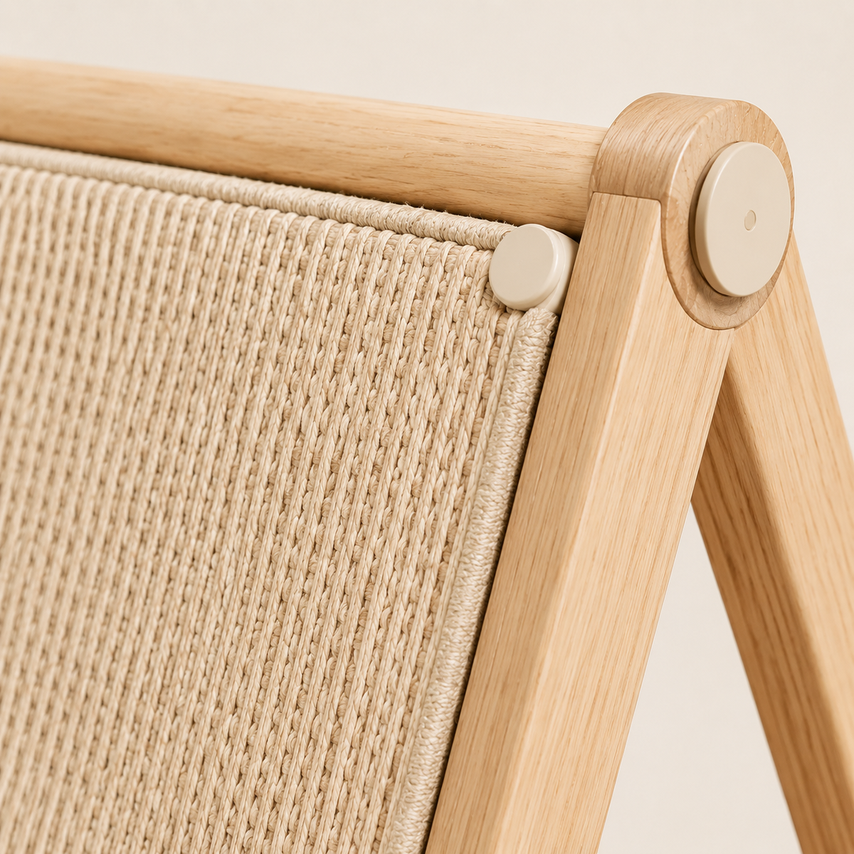 Close-up of the natural sisal fabric, bound panel edge and light wood frame on an A-frame cat scratcher
