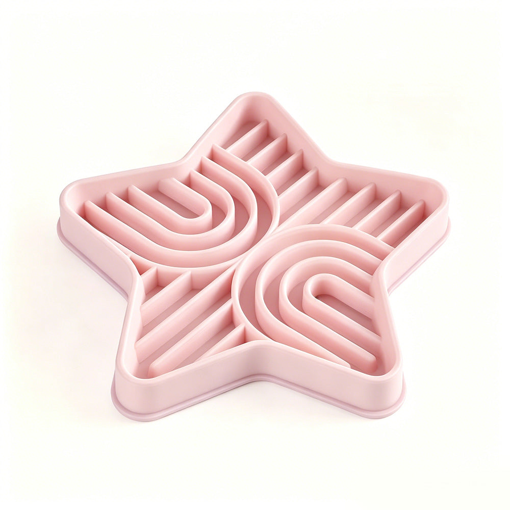 Pet eating from a star-shaped silicone slow feeder mat