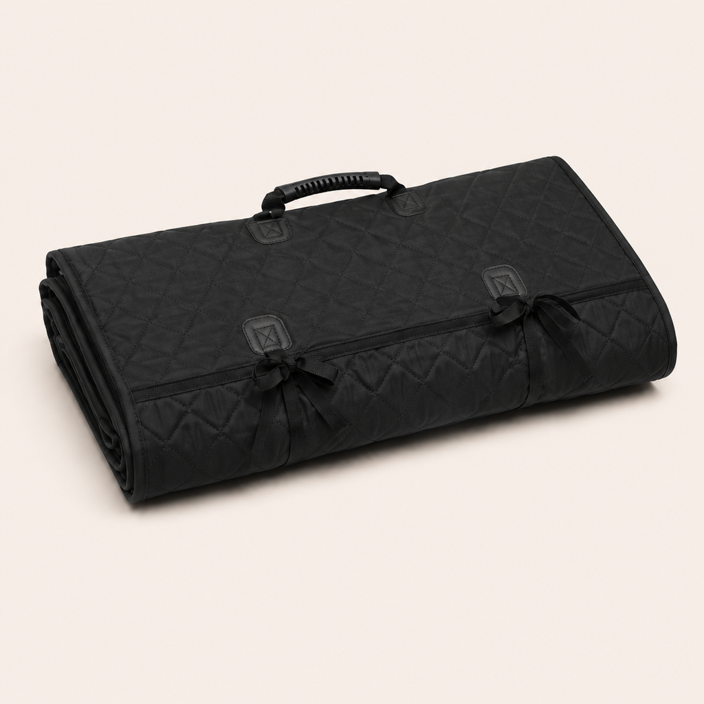 Folded black quilted rear-seat pet protector with carry handle and securing straps