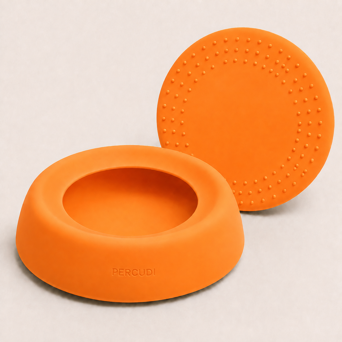 Orange silicone travel water bowl with raised anti-slip bottom details