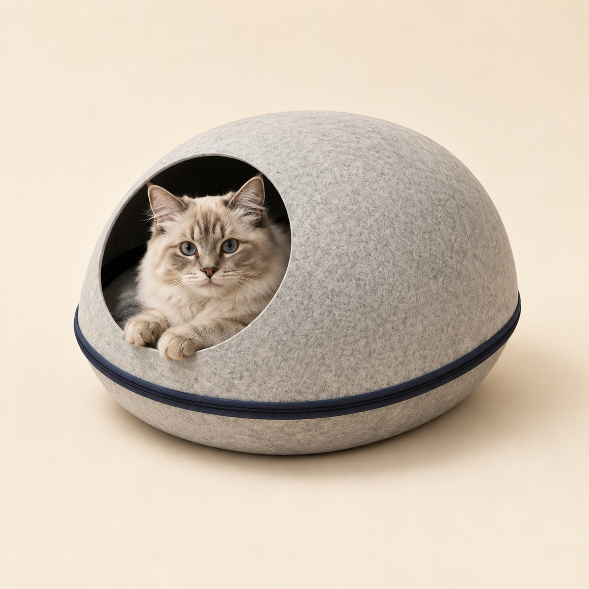 Gray felt egg-shaped cat cave in a warm modern living room