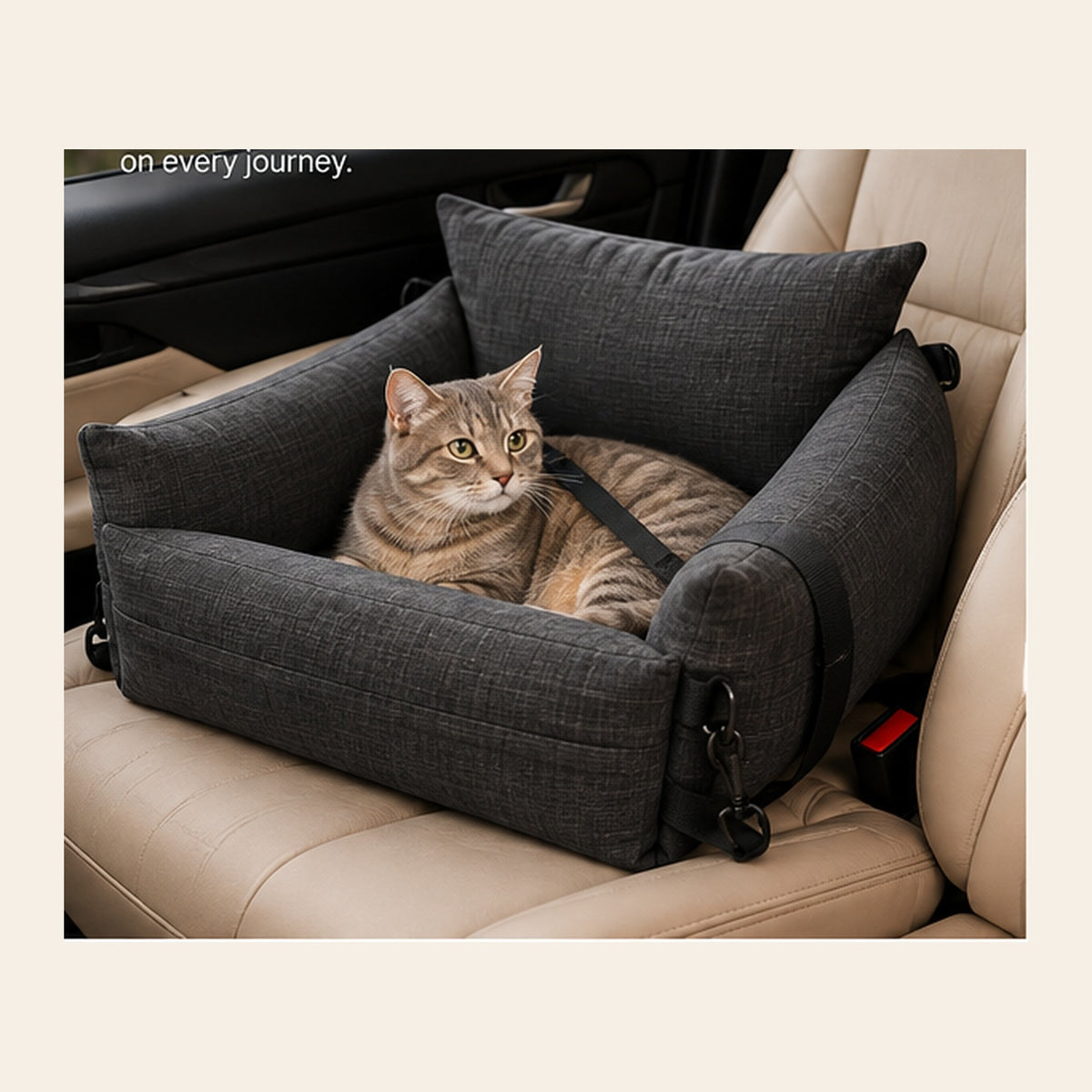 Cat resting in a charcoal gray pet car seat during travel